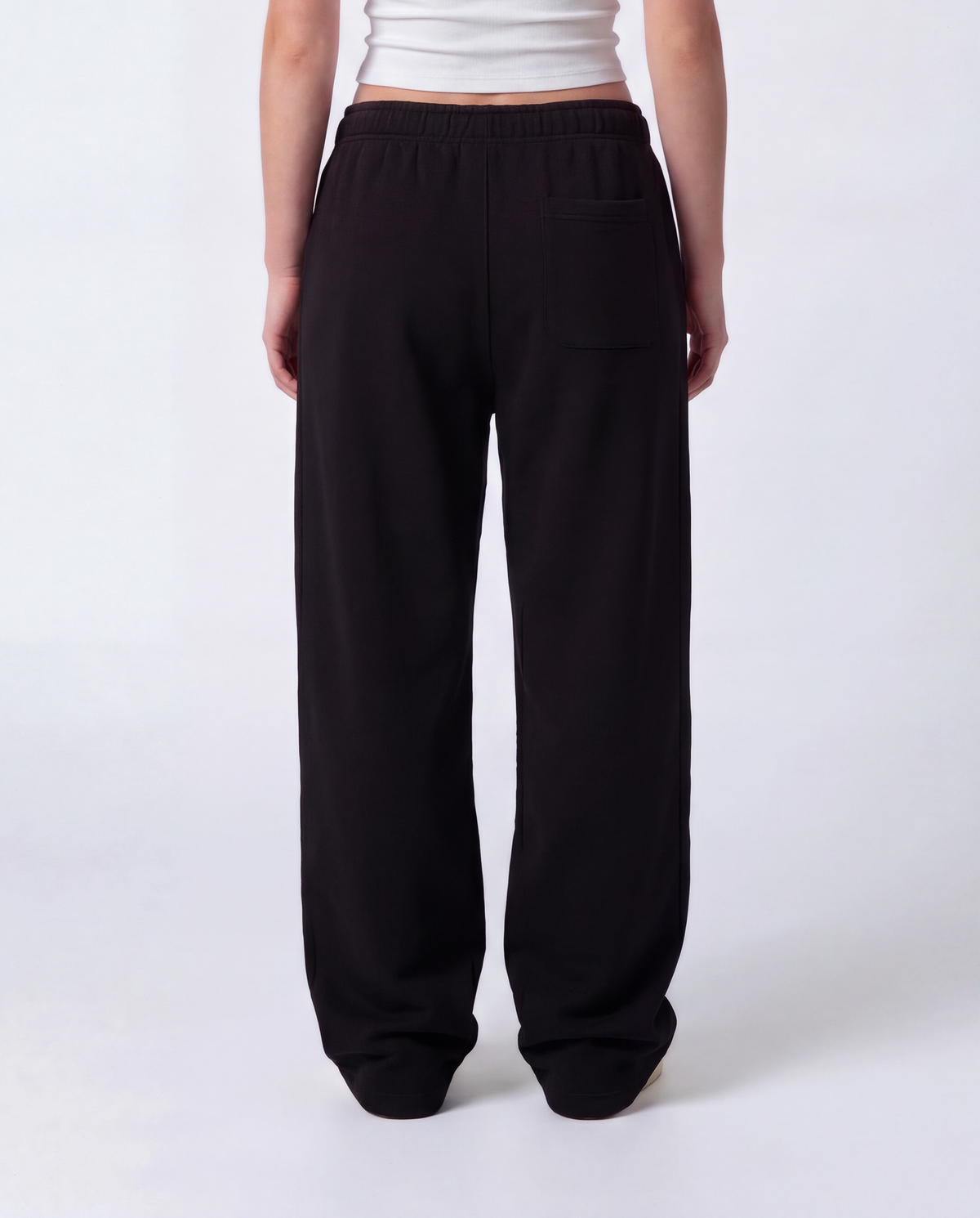 Essential Logo — Carrier Sweatpant — Female model close back (Reese), Black #Model_F #Color_Black