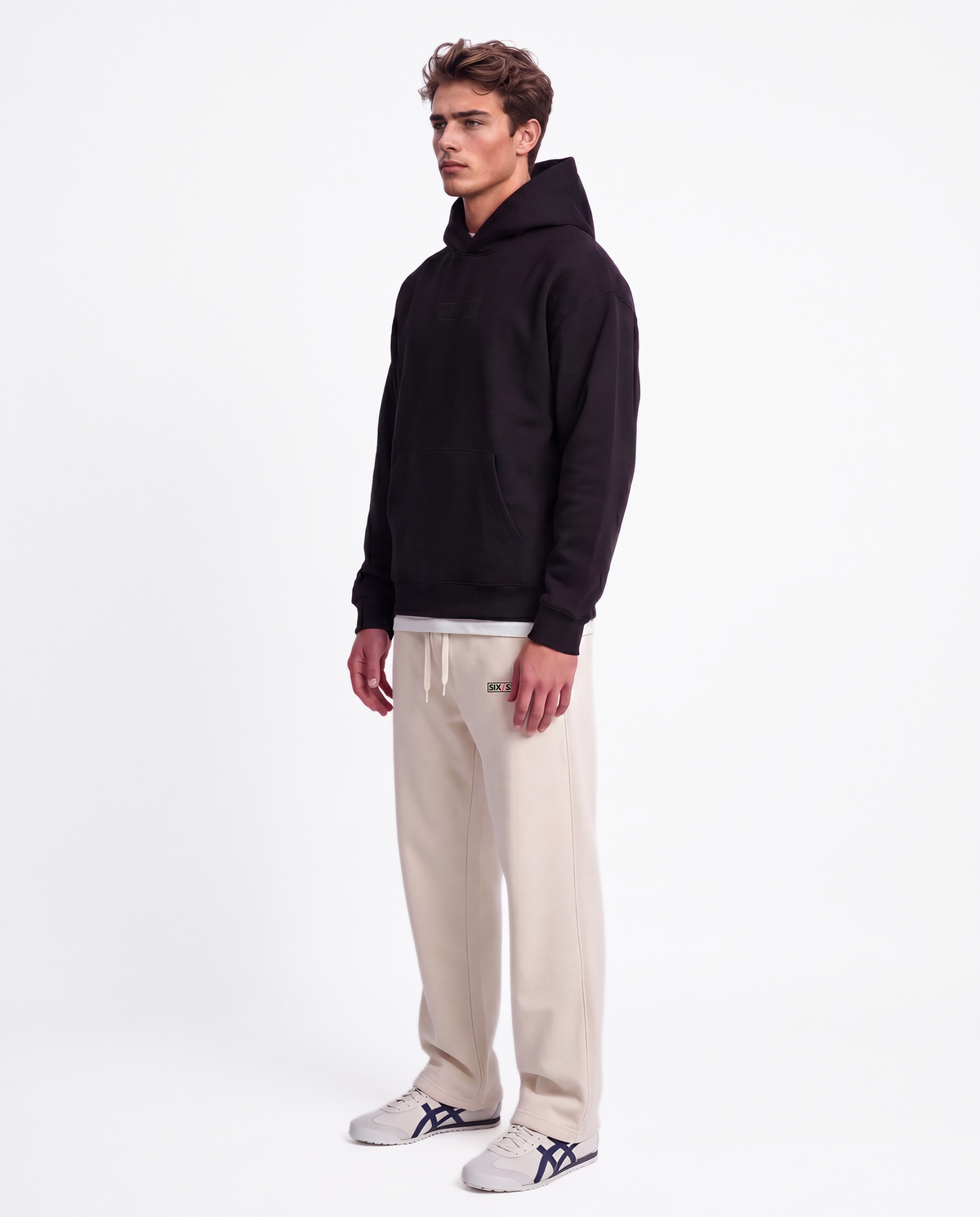 Essential Logo — Carrier Sweatpant — Male model full side (Brooks), Bone #Model_M #Color_Bone