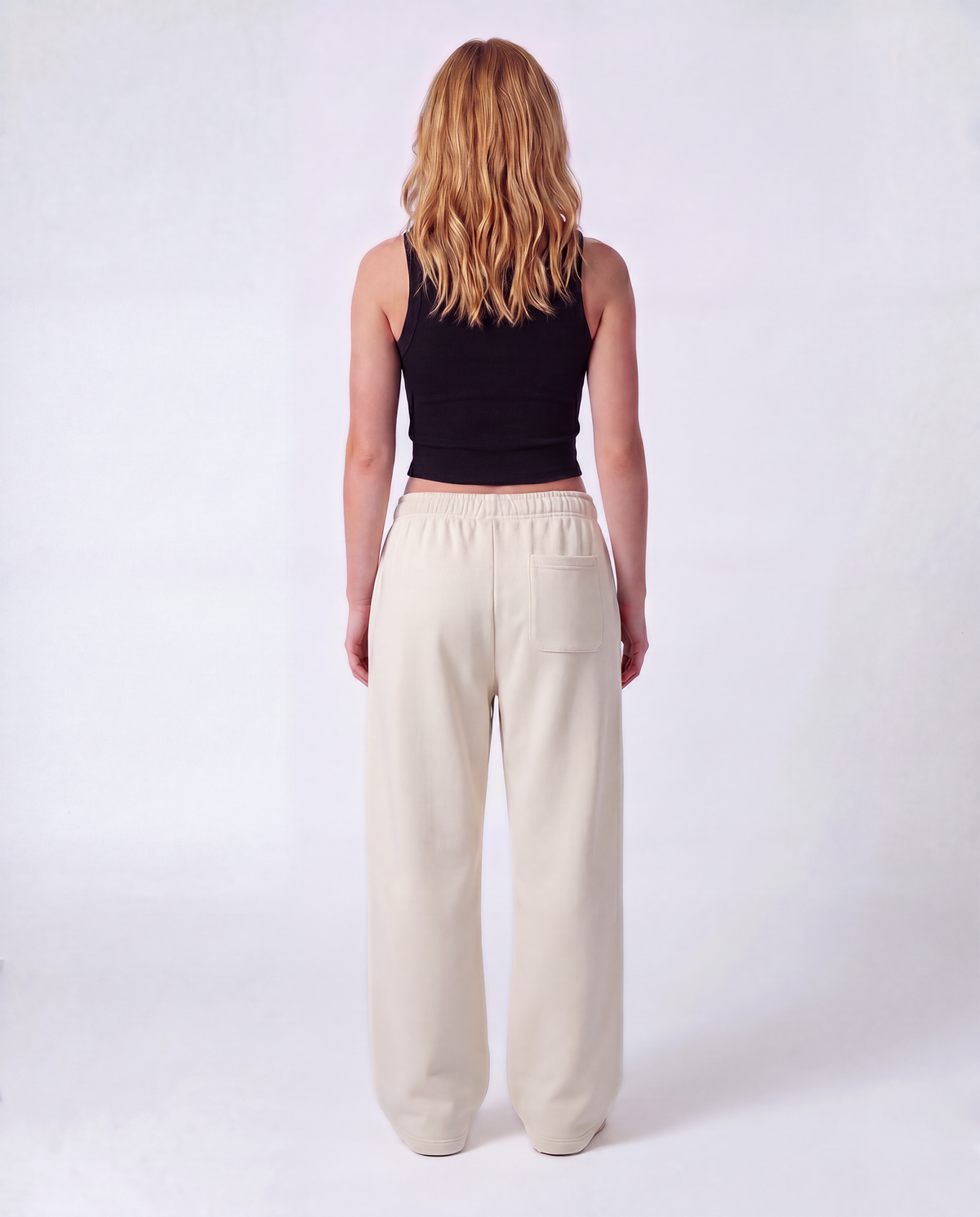 Essential Logo — Carrier Sweatpant — Female model full back (Reese), Bone #Model_F #Color_Bone