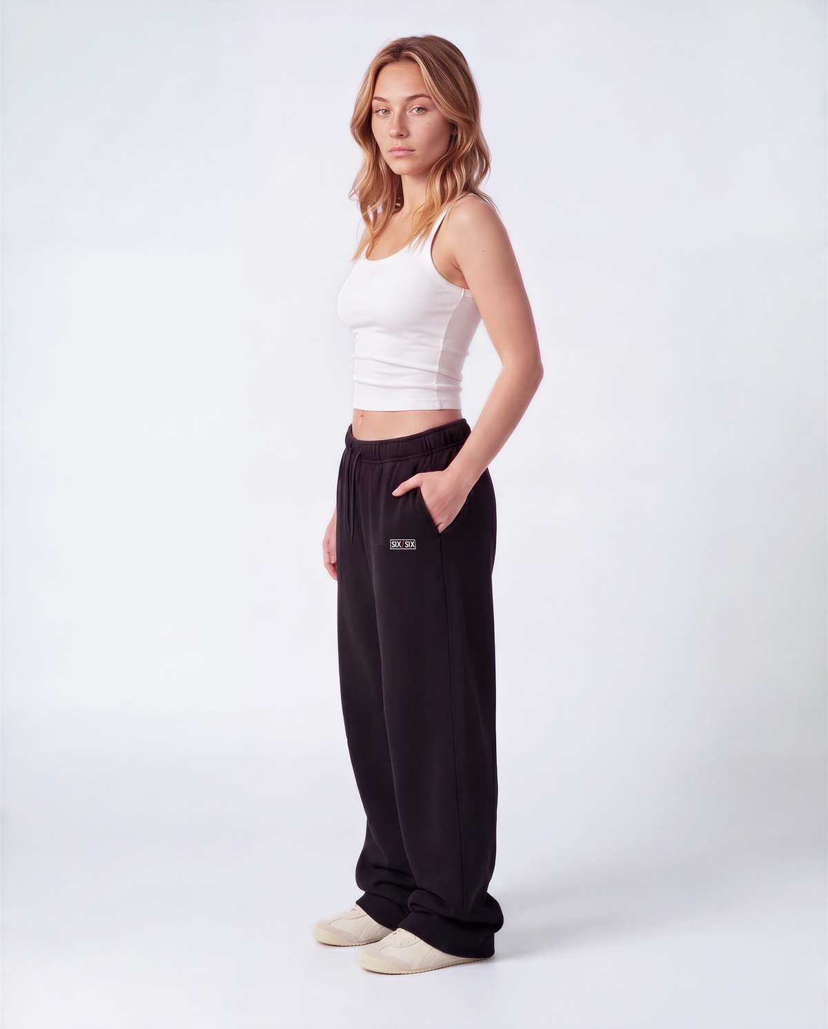 Essential Logo — Carrier Sweatpant — Female model full side (Reese), Black #Model_F #Color_Black