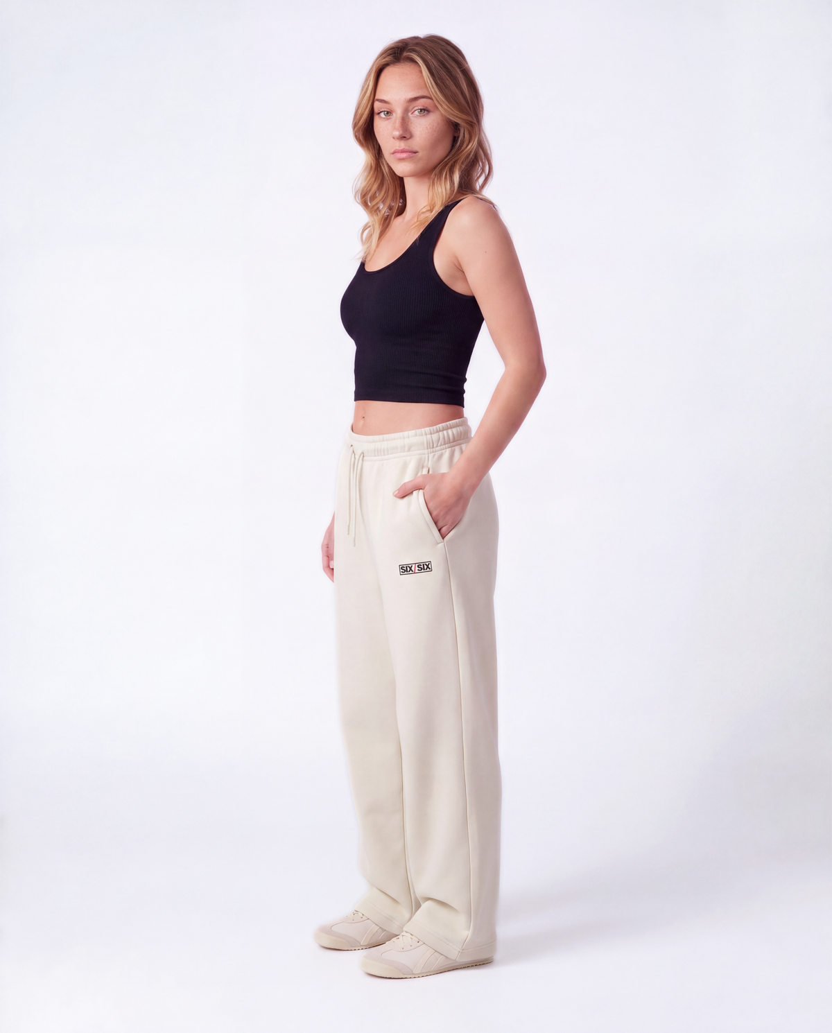 Essential Logo — Carrier Sweatpant — Female model full side (Reese), Bone #Model_F #Color_Bone