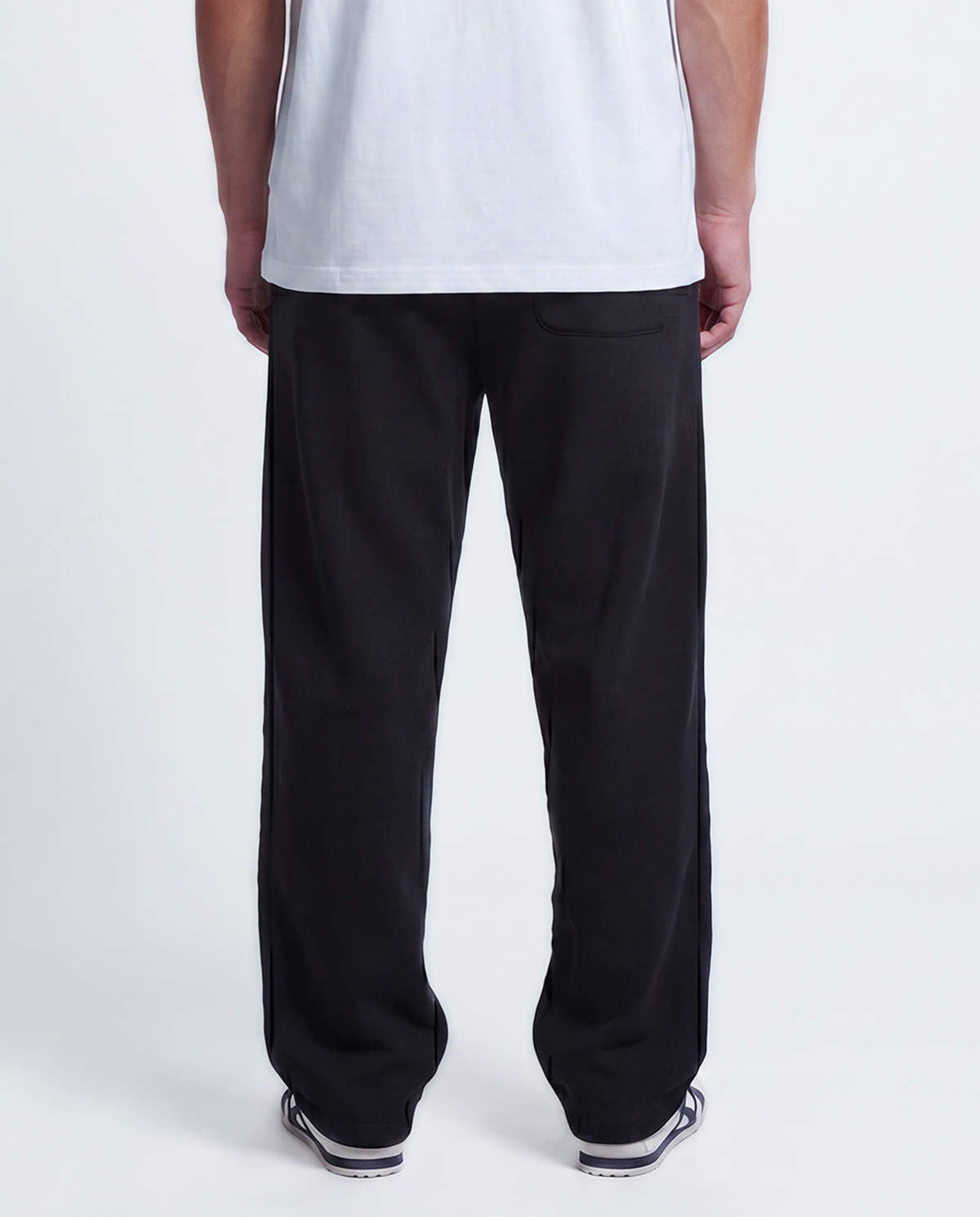 Essential Logo — Carrier Sweatpant — Male model close back (Brooks), Black #Model_M #Color_Black